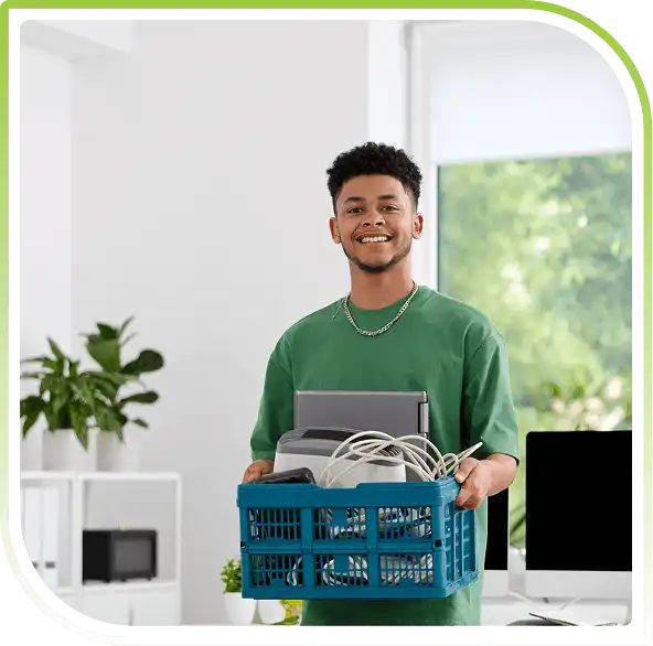 A smiling male holding a blue crate of electronics