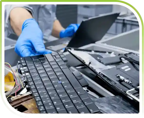 A blue-gloved hand holding up a keyboard