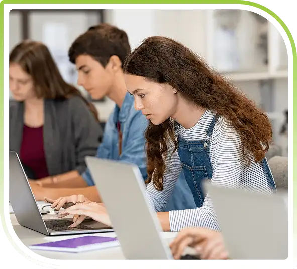 Students using laptops in a classroom setting for digital learning and coursework