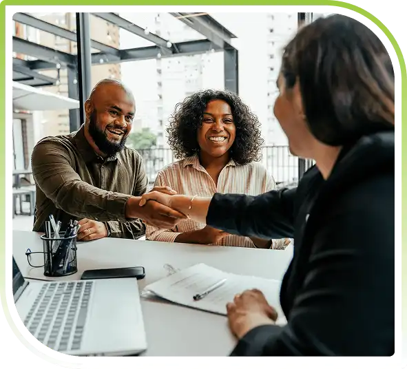 Financial professionals meeting with clients and shaking hands during a business consultation