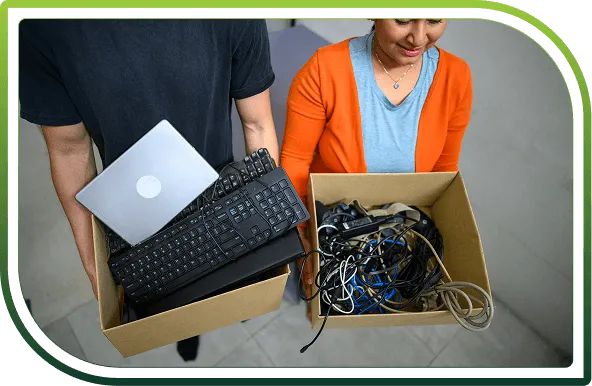 Collected laptops, keyboards, and electronic cables prepared for secure IT asset disposal and ITAD services