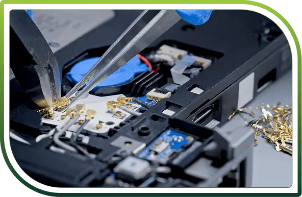 Technician disassembling a laptop keyboard and components, representing secure IT asset disposal and compliant ITAD services.