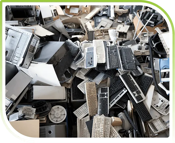 Heap of discarded keyboards and computer hardware, illustrating secure IT asset disposal, disposition, and compliant electronic recycling services.