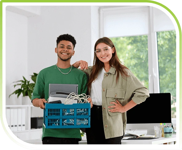 Two professionals holding a box of IT equipment for secure data destruction, representing certified IT asset disposition services.