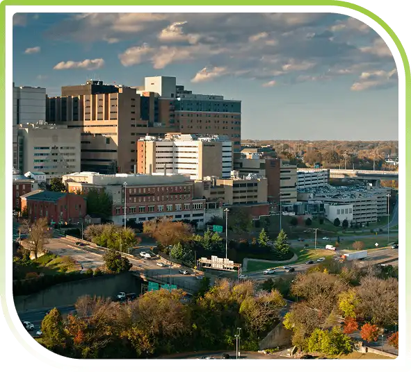Washington DC–Northern Virginia cityscape with modern office buildings, highways, and green spaces under a clear daytime sky.