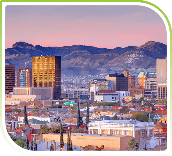 El Paso, Texas skyline at sunset with downtown buildings, colorful rooftops, and the Franklin Mountains in the background.