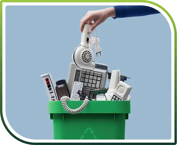 Person removing a dryer from a box filled with electronic waste for responsible recycling disposal.