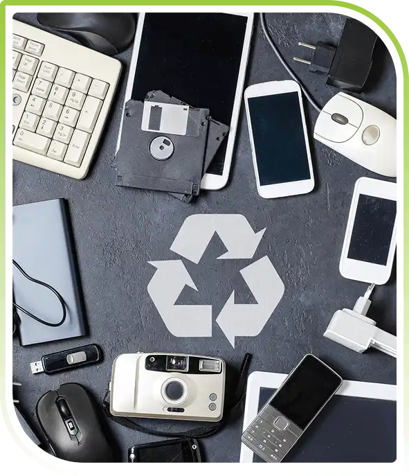 Assorted outdated electronics including keyboard, floppy disk, tablet, smartphone, mouse and charger for recycling.