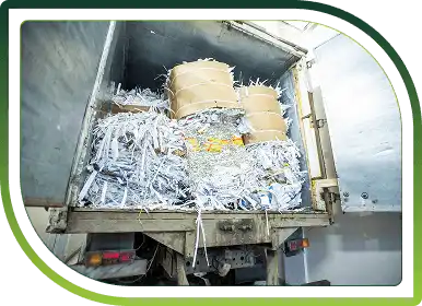 Truck loaded with shredded paper representing secure bulk paper shredding and environmentally responsible recycling services.