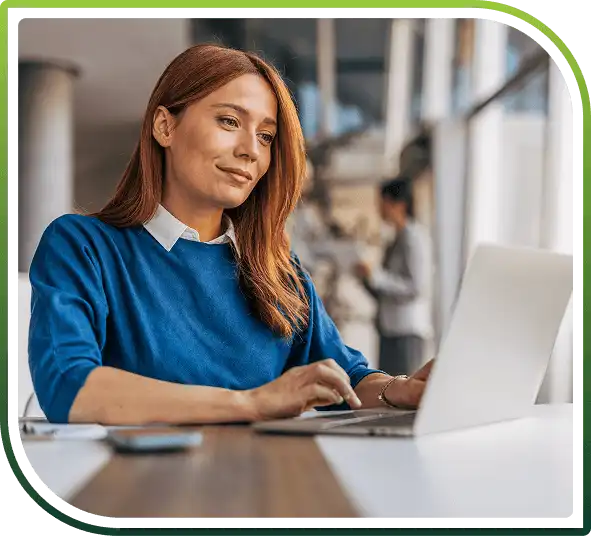 Professional woman working on laptop in modern office, representing ServiceNow integration and digital workflow automation