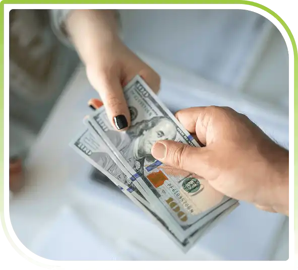 Close-up of two hands exchanging US dollar bills, symbolizing secure financial transactions and payments integration.